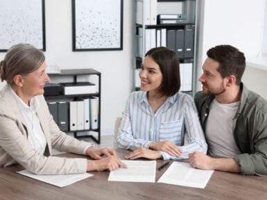 a young couple signing documents